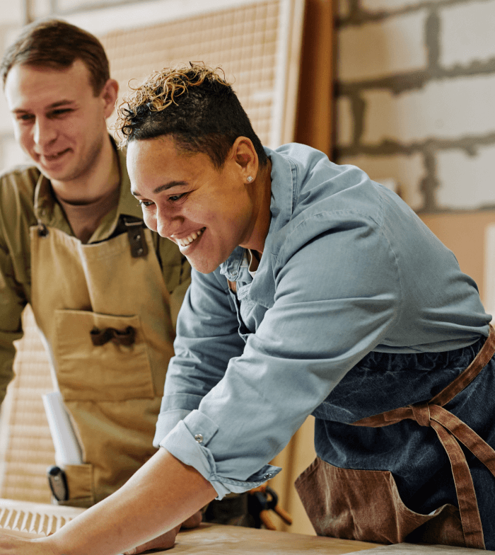 Balance B2C & B2B Commerce Case Study, Mitre 10 - two people in tool workshop working on a project